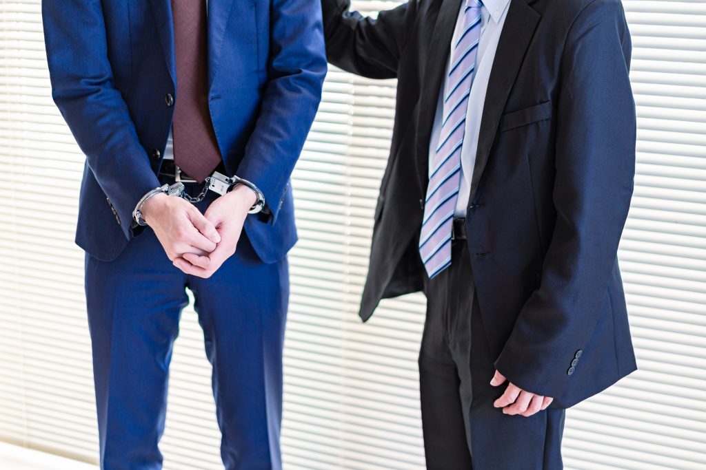 an arrested man with his criminal defense attorney