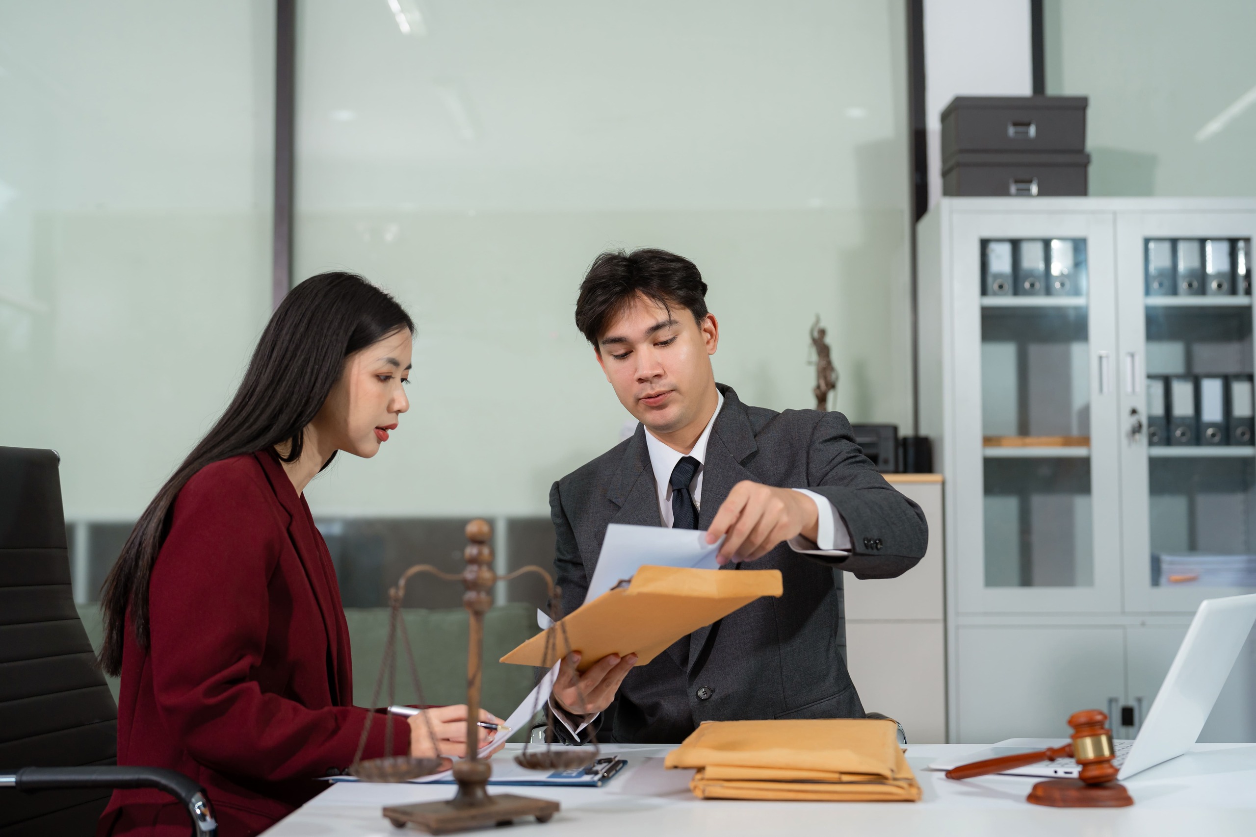 A client and lawyer review case documents in a theft or misappropriation matter.